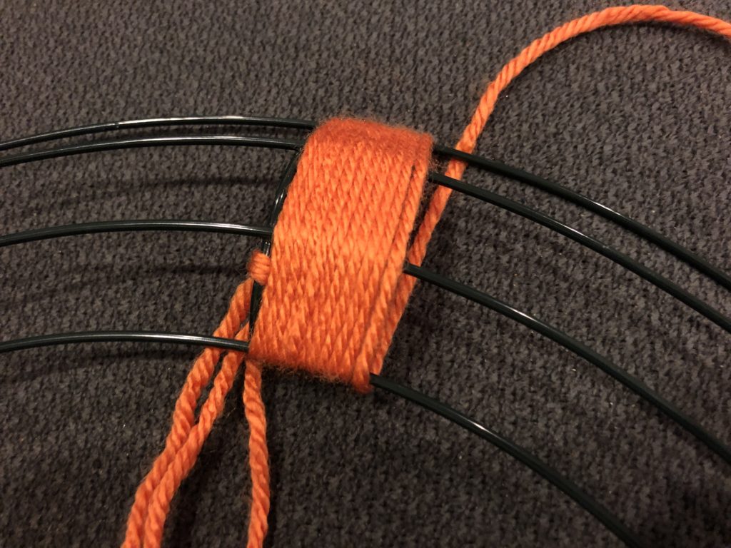 a close-up look at yarn wrapped around a wire frame