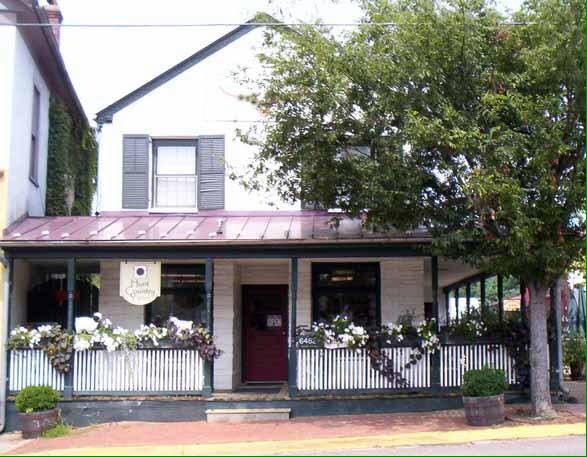 the storefront of Hunt Country Yarns, a small cottage with flowers on the front porch