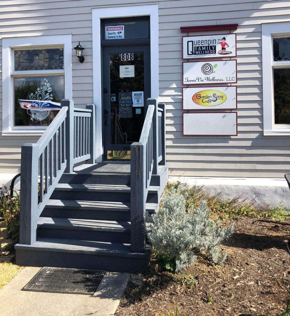 a shop door with adjacent signage that reads Garden Song Café