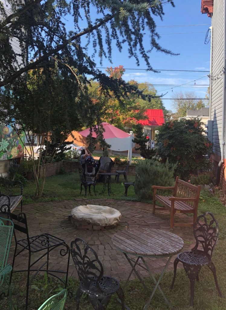 benches, chairs, and tables in a hidden garden