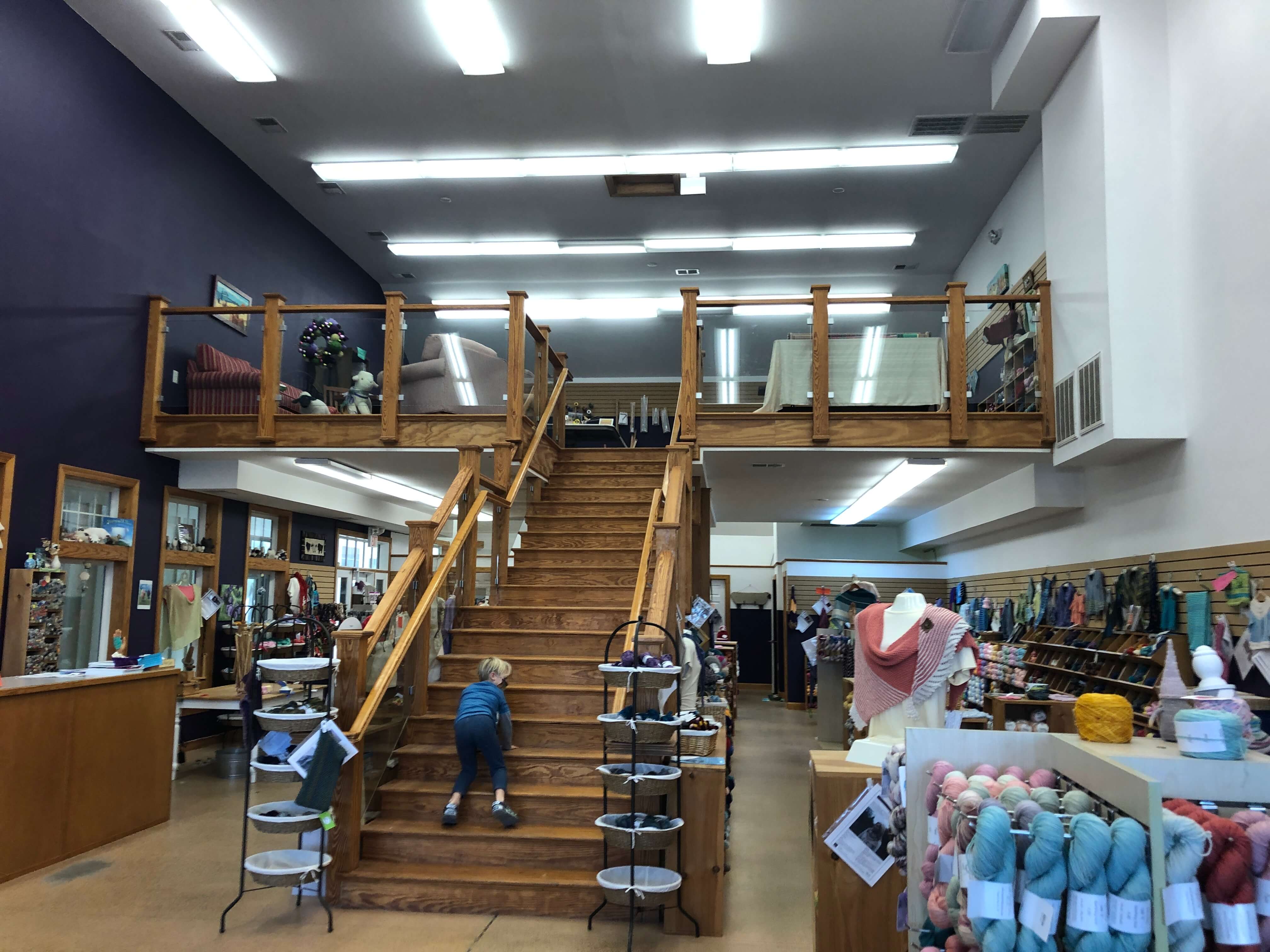 Knitting Addiction store with a loft and stairs to the loft in the center