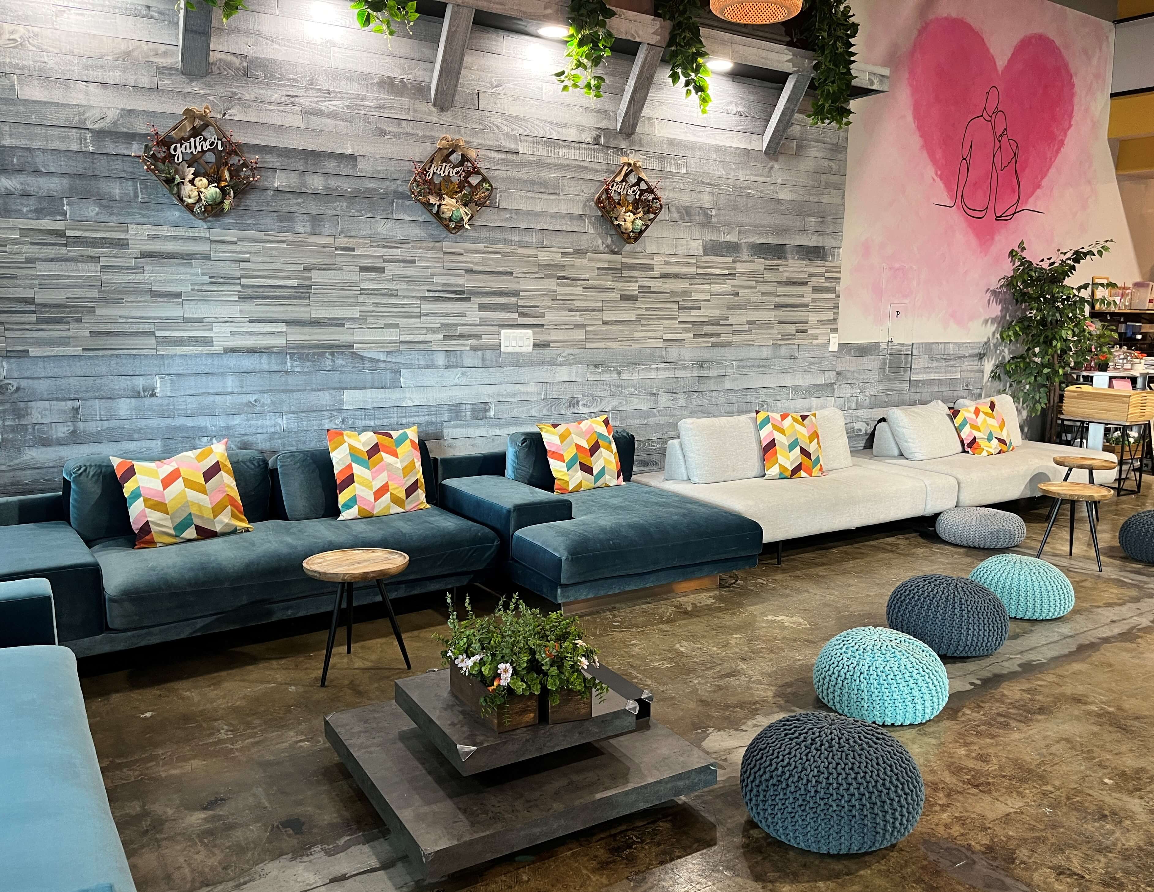 a casual seating area at Epiq Food Hall features poufs and chaise lounges