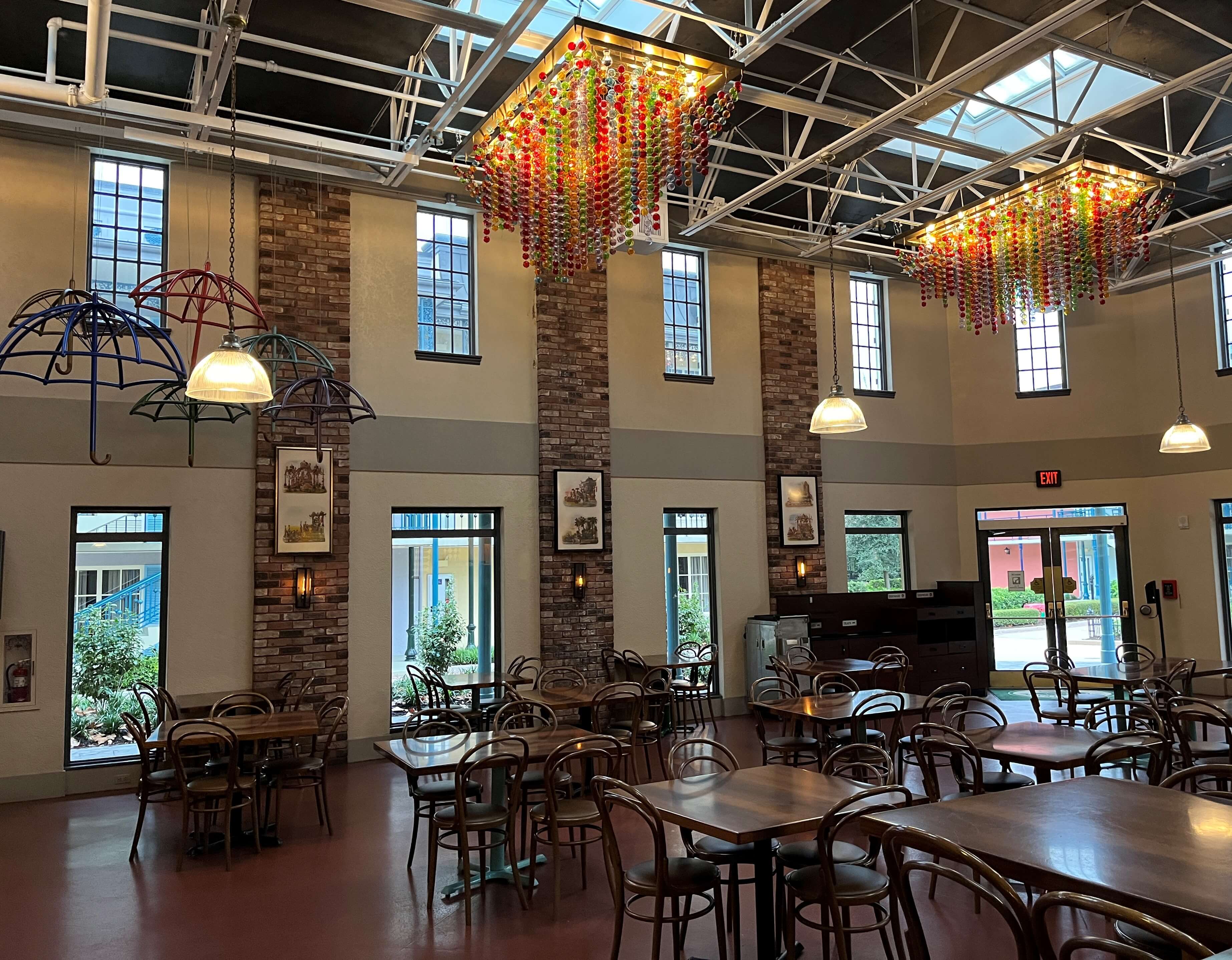 umbrellas and beads dangle under skylights and above dining tables in a long food hall